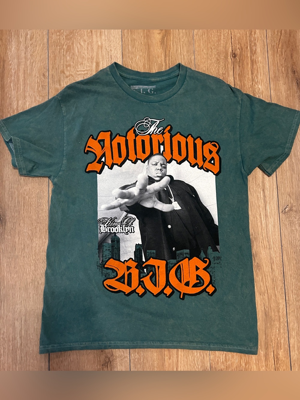 Vintage-Style Green Short-Sleeve Graphic Tee with Bold Orange Print